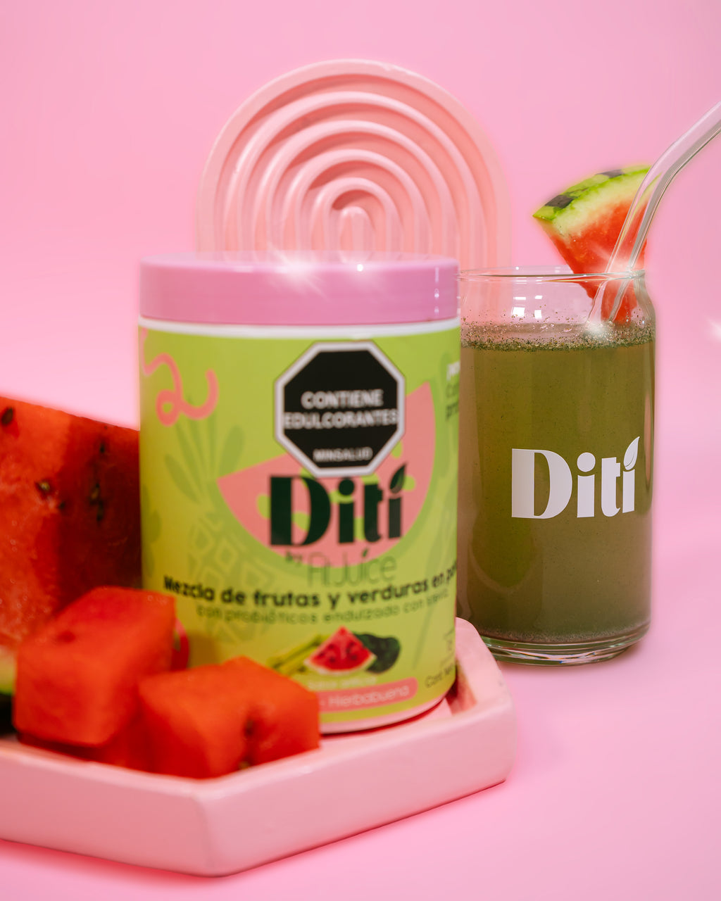 Diti product packaging with a glass of juice and watermelon on a pink background